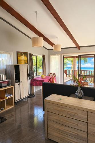 a living room with a couch and a table at Sunset Palms Rarotonga in Rarotonga