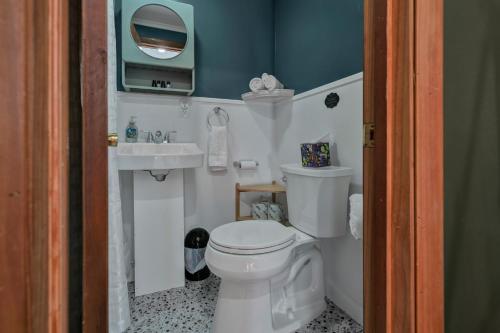 a small bathroom with a toilet and a sink at Berkshire Lake Lodge in Becket