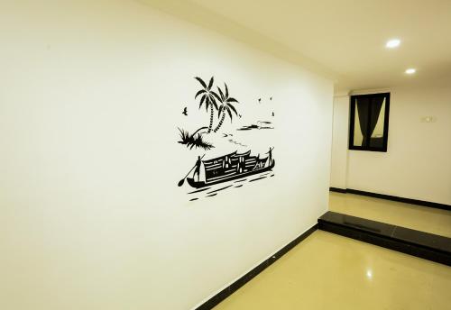 a room with a wall with a drawing of a boat at Motel La Grandeur in Mapusa