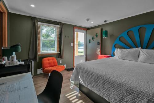 a bedroom with a bed and a desk and a chair at Berkshire Lake Lodge in Becket