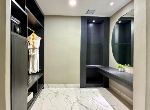a dressing room with a mirror and a dressing table at Emersia Hotel & Resort Batusangkar in Batusangkar
