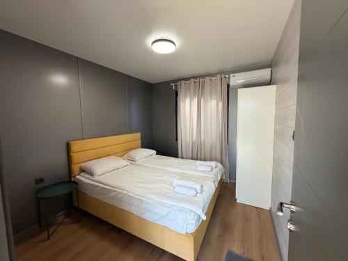 a small bedroom with a bed with white sheets at Еко Къмпинг Созопол in Sozopol