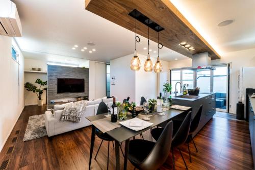 a dining room and living room with a table and chairs at ResoLife in Kochi