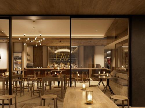 a restaurant with tables and chairs and a bar at FAV LUX Asahikawa in Asahikawa
