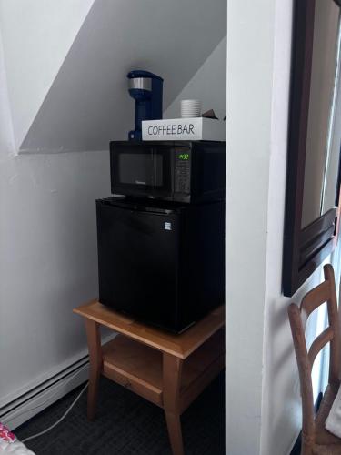 a coffee bar sign on top of a microwave on a table at Ocean Spray Inn in Winthrop