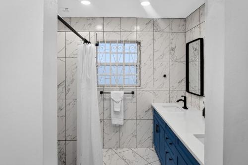 a bathroom with a shower and a sink at Villa del Nique in Pembroke