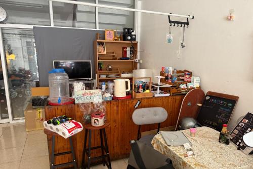 a cluttered room with a desk with a computer on it at Sleep Break Hostel Sathon in Bangkok