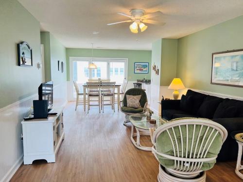 a living room with a couch and a table at Tradewinds in Holden Beach