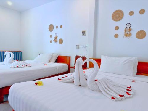 a room with two beds with swans on them at Home Escape Resort in Phumĭ Bát Tráng (2)
