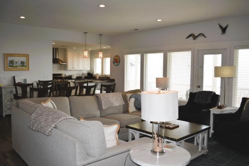 a living room with a couch and a table at Nautilus Home in Holden Beach