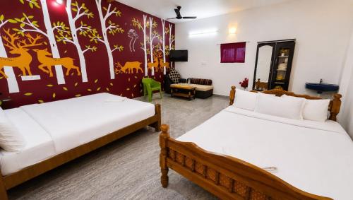 a bedroom with two beds and a living room at Happy Mates Forest Villa in Pondicherry