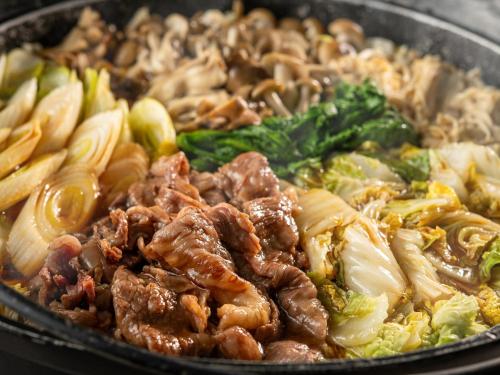 a pan full of food with meat and vegetables at Daitokan in Kusatsu