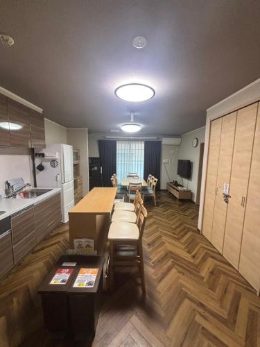 a kitchen with a table and a dining room at Yasuragi-KAWAGOE 1F in Kawagoe