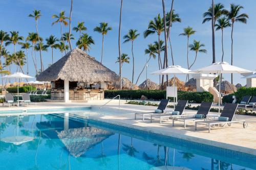 a pool at a resort with palm trees at Paradisus by Meliá Palma Real Golf and Spa Resort - All Inclusive in Punta Cana