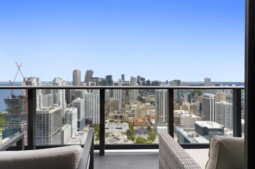 a balcony with chairs and a view of a city at Luxury Penthouse Best Price ,Breathtaking Balcony Views, Ocean & City, Resort Pool, Spa, Gym, in Miami