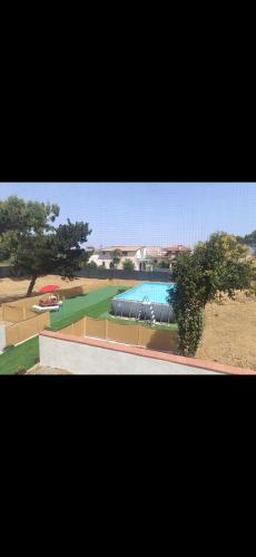 a view of a building with a pool in a park at Residence la Duna in Castel Volturno