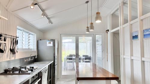 a kitchen with a counter top and a refrigerator at Jack s Cottage in Wooli