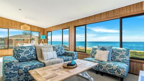 a living room with a view of the ocean at Kokomo in Wooli