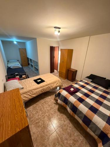 a hotel room with two beds in a room at La Cumbre in Chos Malal