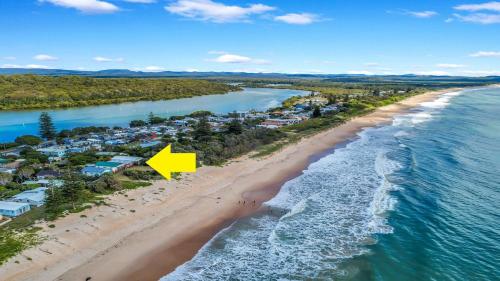 an aerial view of a beach with a yellow arrow at Moomba On Main in Wooli
