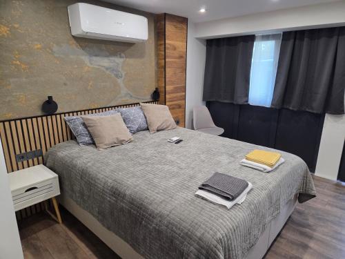 a bedroom with a bed with two towels on it at Fragma in Targovishte