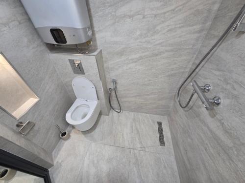 a bathroom with a toilet in a shower stall at Fragma in Targovishte