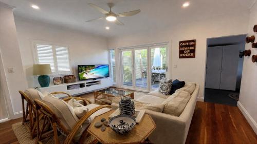a living room with a couch and a table at Sea Legs in Wooli