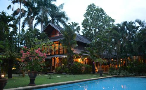 a house with a swimming pool in front of it at Villa Una in Seminyak
