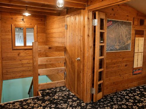a wooden room with a sauna at Maple House Backpackers in Iiyama