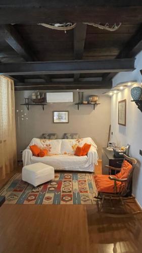 a living room with a bed and a table and a rug at Gabry’s Home in Pianello Del Lario