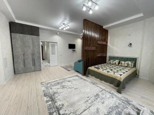 a bedroom with a bed and a couch in it at Asia Street in Bishkek