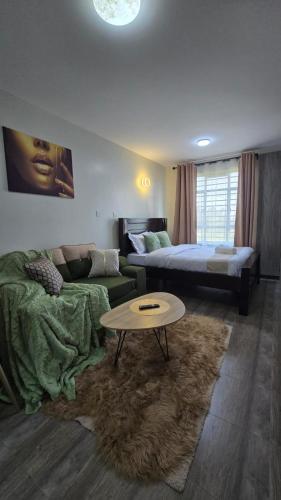 a living room with a couch and a table at Luna homes in Ruaka