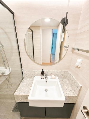 a bathroom with a sink and a mirror at 플럼바고올스위트34 in Chosan-ni