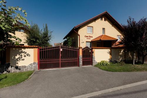 a house with a red gate in front of it at Casa Dava in Râşnov