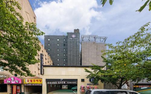 a building with a clock tower on top of it at Brown Dot Hotel Guun in Suwon