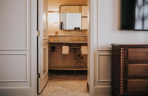 a bathroom with a sink and a mirror at The Driskill in Austin