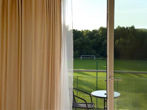 a view of a soccer field from a window at HORN Jastarnia in Jastarnia
