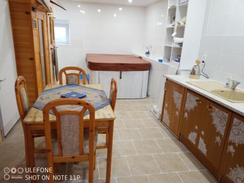 a kitchen with a table and chairs and a sink at la bergerie in Cronce