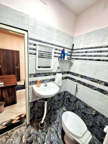 a bathroom with a sink and a toilet at Mona Homestay in Sambalpur