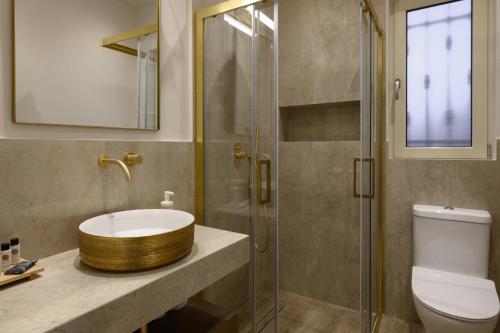 a bathroom with a sink and a glass shower at The Seasons in Svoronata