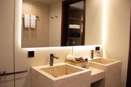 a bathroom with two sinks and a large mirror at Boutique Hotel 19D in Almaty