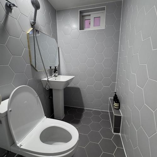 a bathroom with a white toilet and a sink at Hotel AMY in Incheon