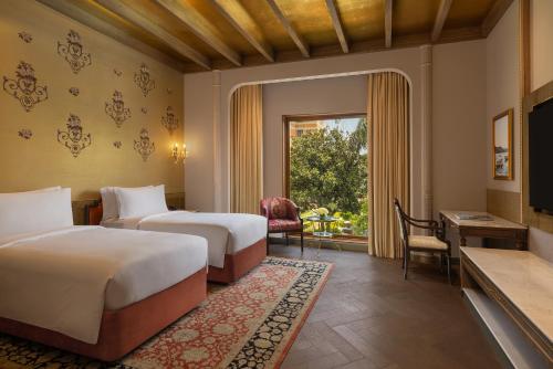 a hotel room with two beds and a window at The Soaltee Kathmandu, Autograph Collection in Kathmandu