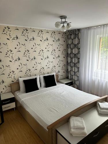 a bedroom with a large bed with a white bedspread at Casa Corvin View in Hunedoara