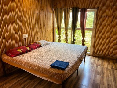 a bed sitting in a room with a window at Homestead thapli in Pinjaur