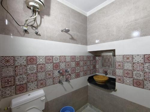 a bathroom with a toilet and a tub and a sink at Third eye view hotel and hostel in Jaisalmer