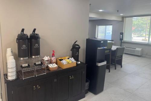 a waiting area of a restaurant with a counter and a table at La Quinta Inn by Wyndham Auburn Worcester in Auburn