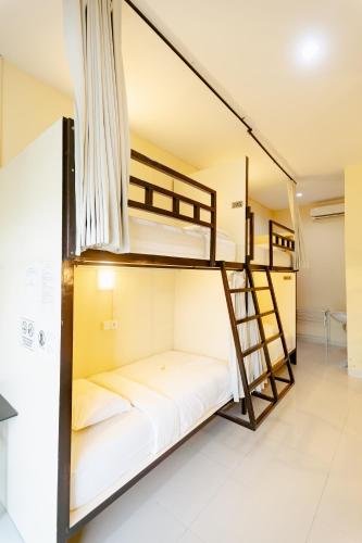 two bunk beds in a room with a staircase at V Canggu Dormitory in Canggu