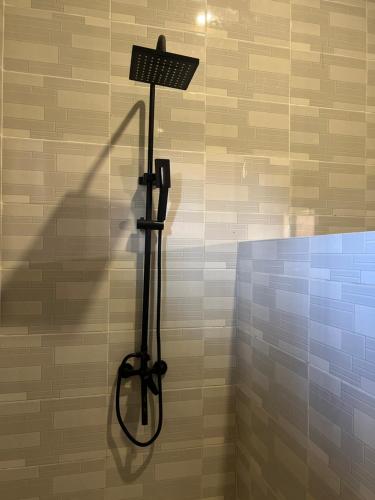 a shadow of a shower head on a wall at Garden Breeze in Bwejuu
