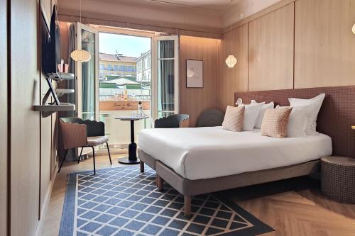 a hotel room with a bed and a window at Hotel Aparthotel AMMI Nice Lafayette in Nice